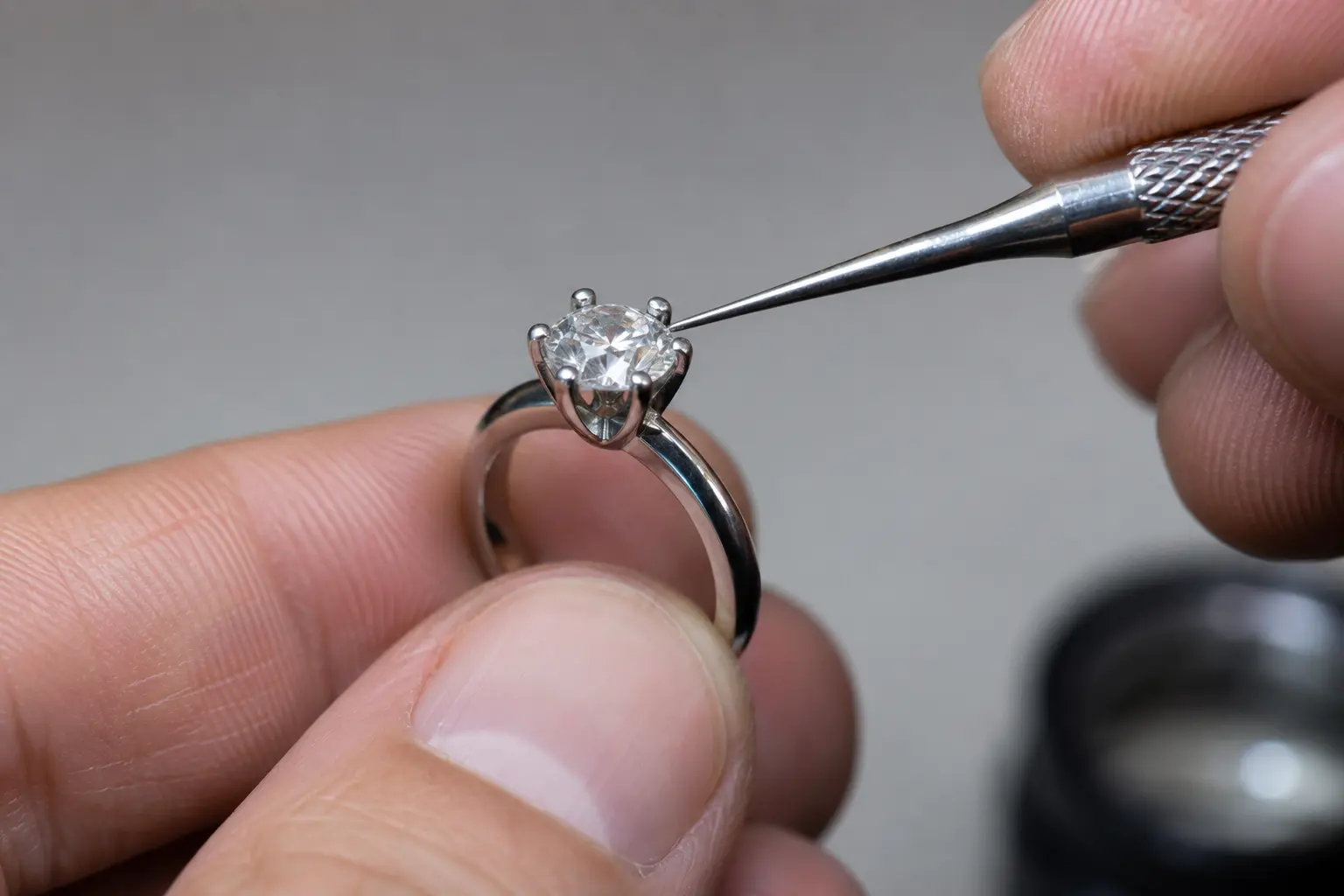Jeweler checking the prongs of a diamond ring for long-term wear