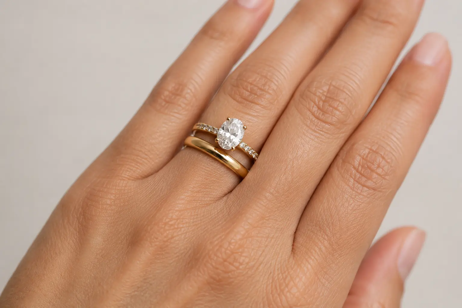 Engagement ring stacked above a wedding band on the ring finger