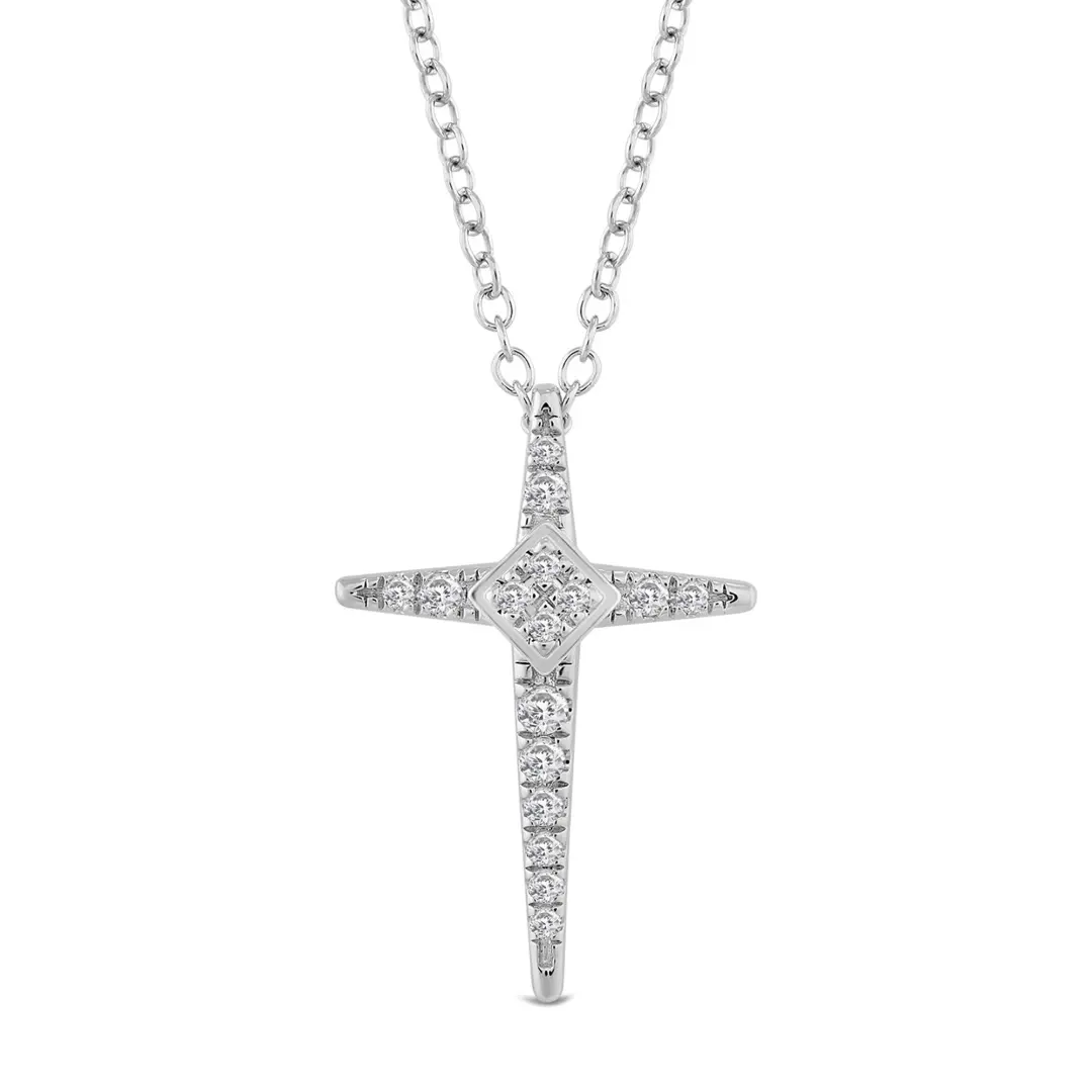close view of an 18k white gold diamond cross pendant with prong-set natural diamonds and a raised star-point center
