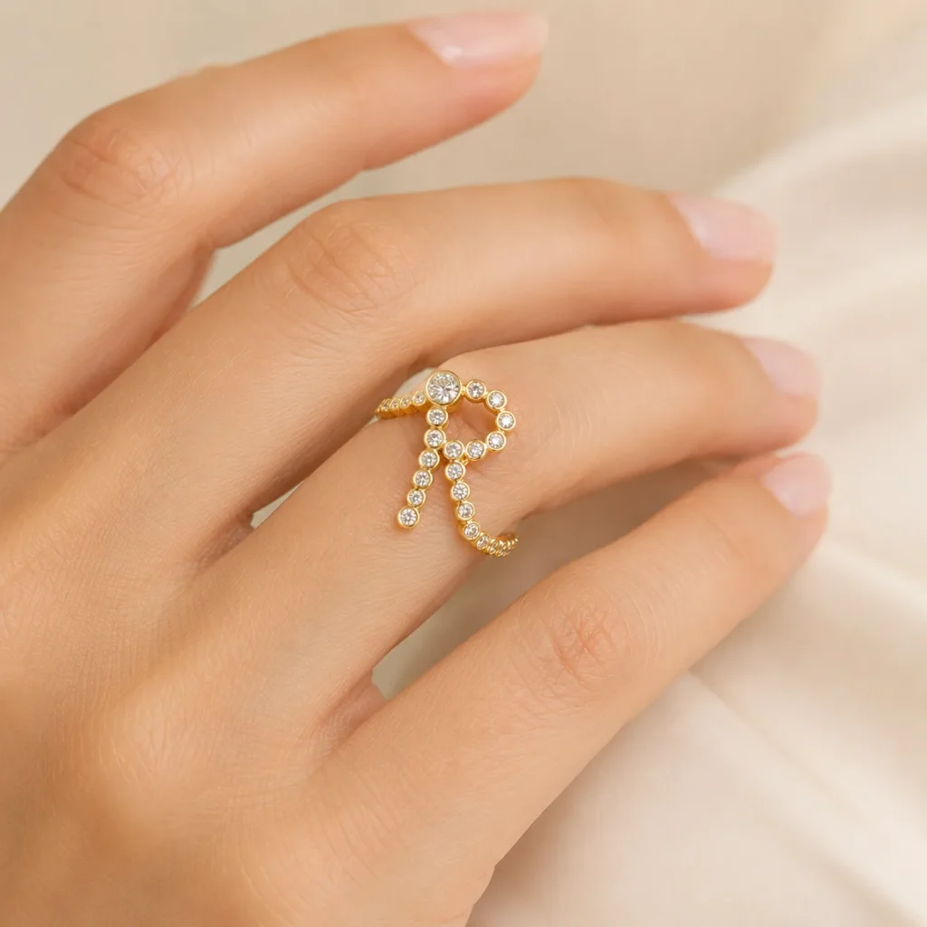 Lab diamond letter R ring in 18K yellow gold worn on a hand