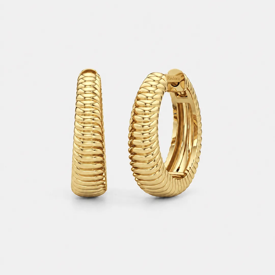 ribbed gold hoop earrings in solid 18k yellow gold, a coiled rib texture wrapping the hoop