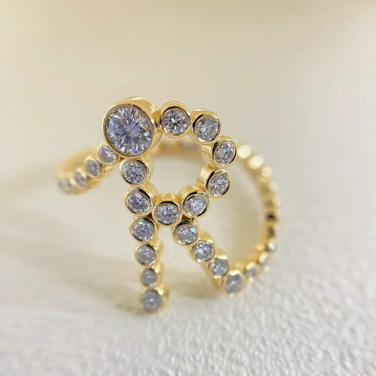 Finished custom initial ring in 18K yellow gold with 46 bezel set lab grown diamonds