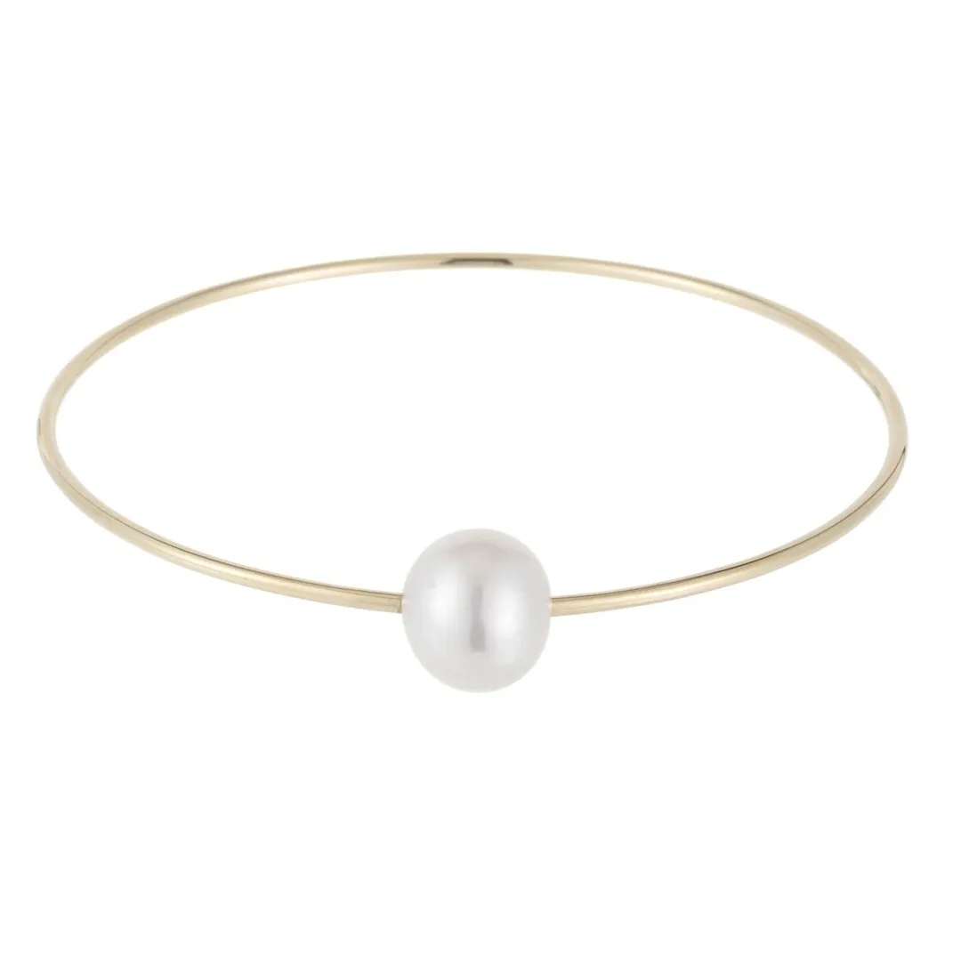cultured pearl bangle bracelet in 14k yellow gold with one oval bead on a slim closed wire circle, product view
