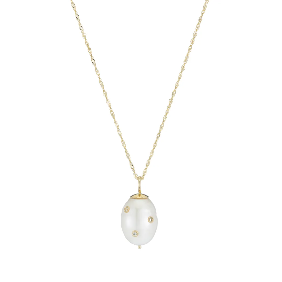 diamond studded cultured pearl pendant on a fine yellow gold chain with three round accents on the baroque drop