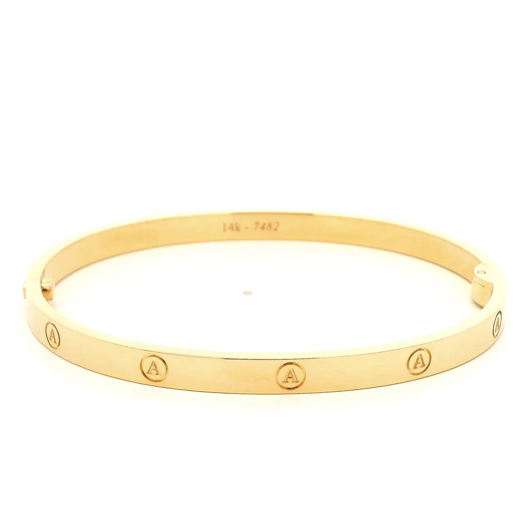 engraved gold bangle in 14k yellow gold with letter a roundels, front view